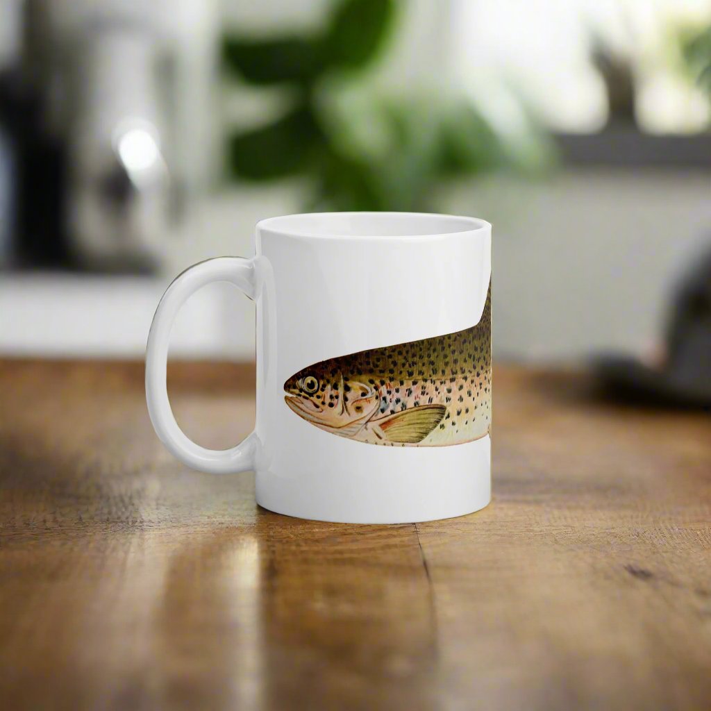 coffee mug with a stealhead trout design sitting on a kitchen table