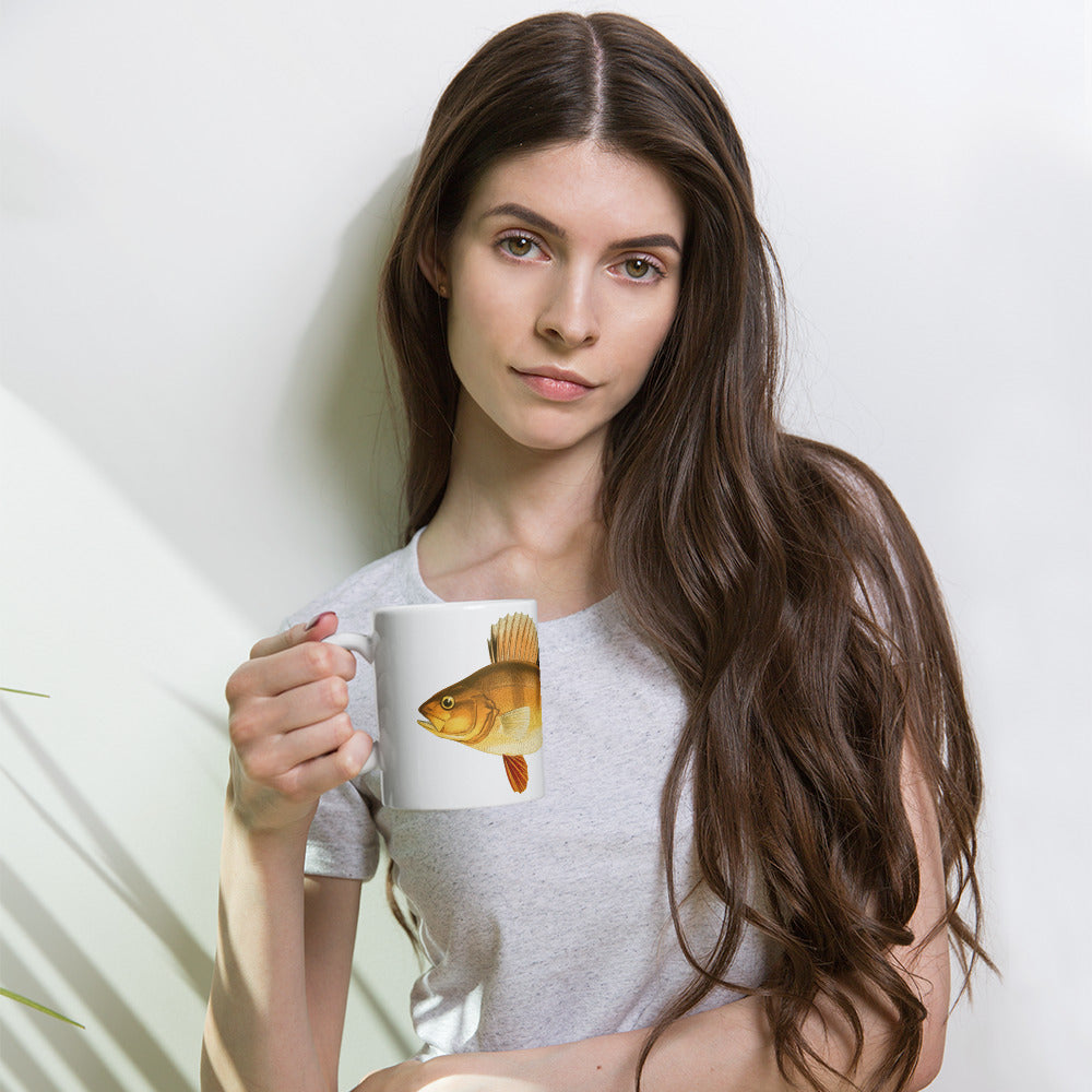 woman holding a coffee mug with a yellow perch design